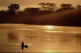 pastoral canoe scene on quiet african river